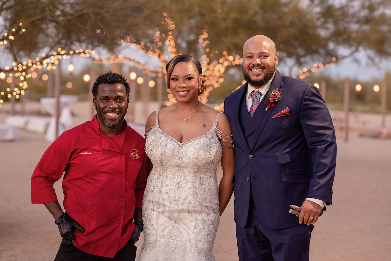 Chef Terry Matthews with bride and groom at Phoenix desert wedding reception with string lights