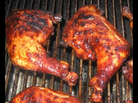Grilled chicken leg quarters over live fire
