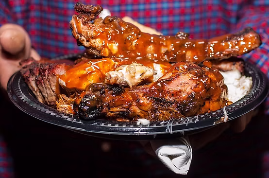 Catered wood-fire dinner plate with brisket, baked beans and mac and cheese at a Qfire Catering private event