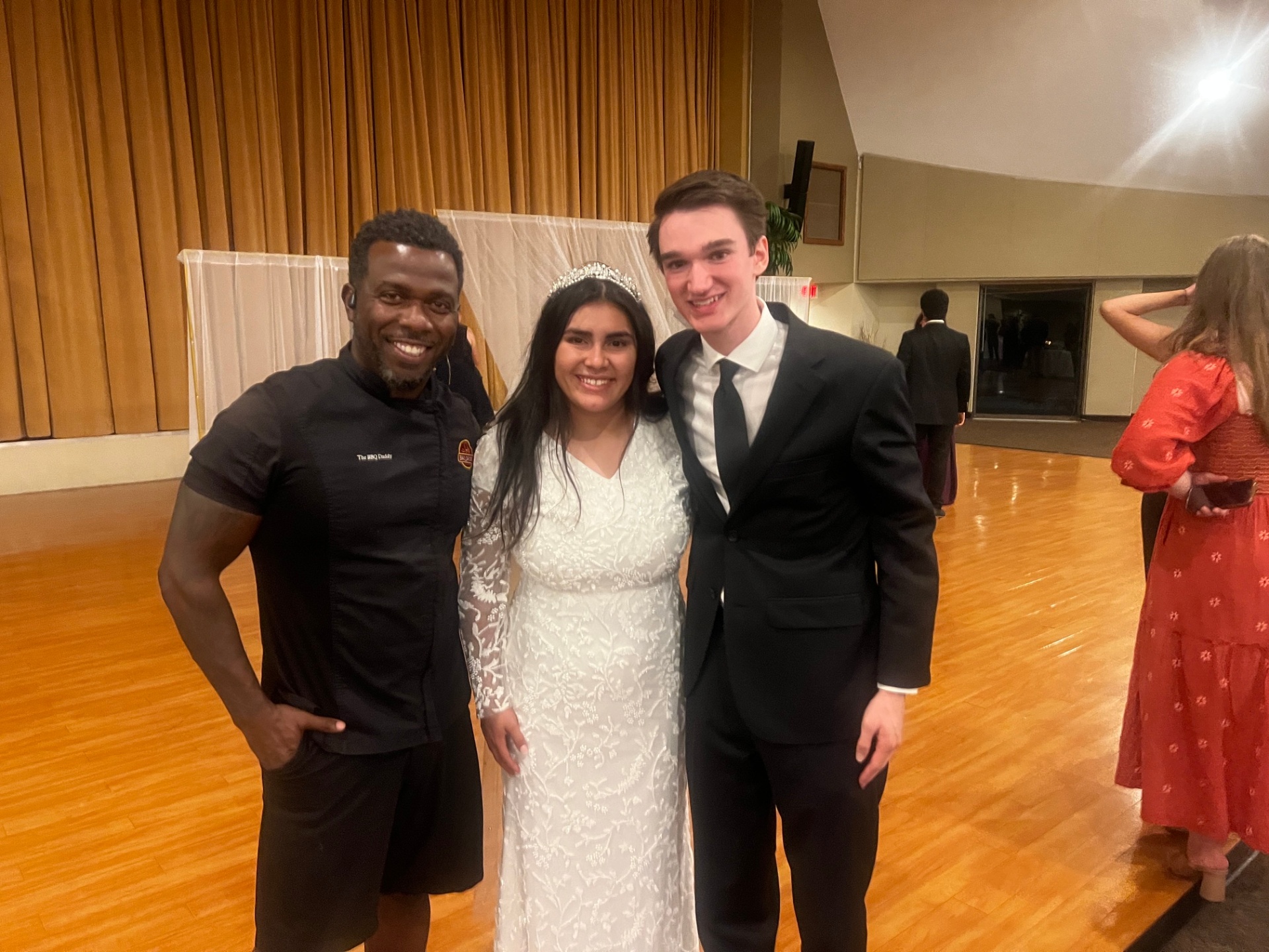 The BBQ Daddy with newlyweds at a Phoenix ballroom wedding reception