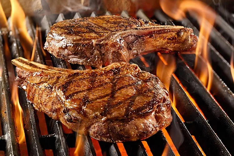 Ribeye steak grilled over an open wood fire
