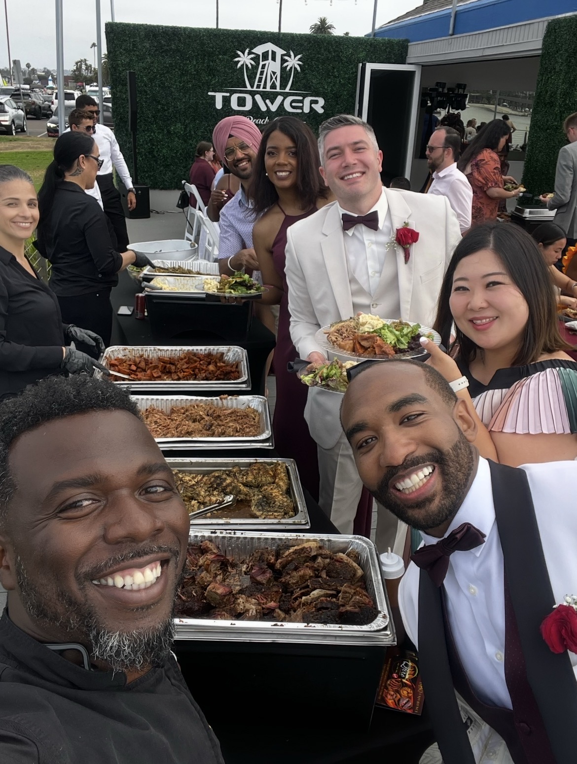 The BBQ Daddy selfie with wedding guests and groom at a San Diego County wedding buffet at Tower Beach