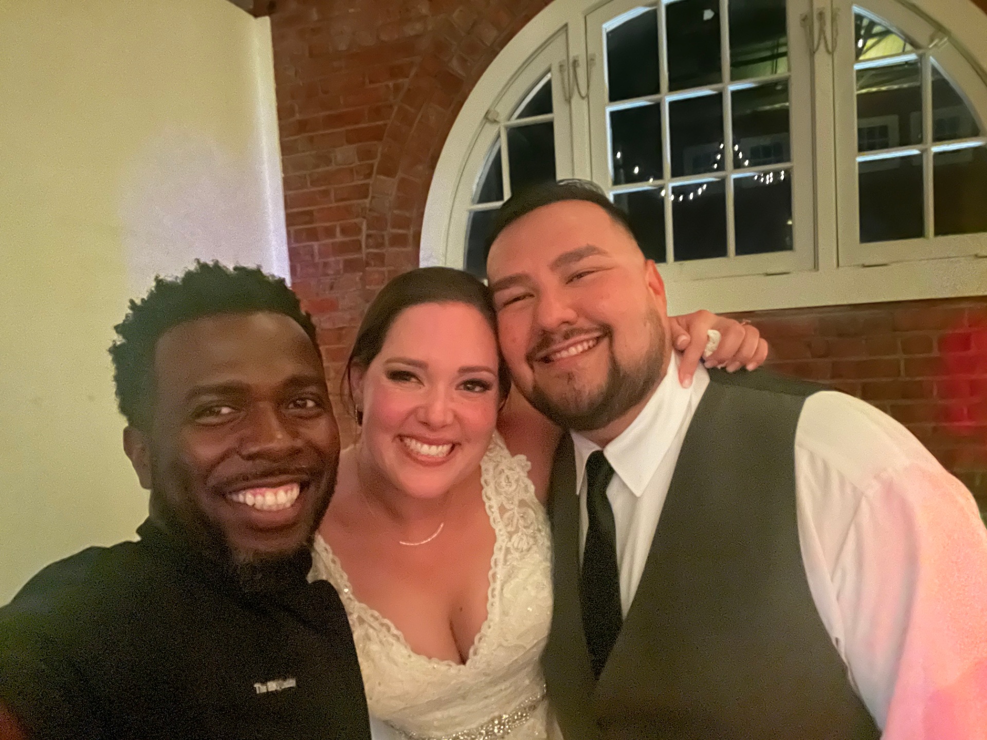 The BBQ Daddy selfie with bride and groom inside a brick-walled Phoenix Metro wedding venue