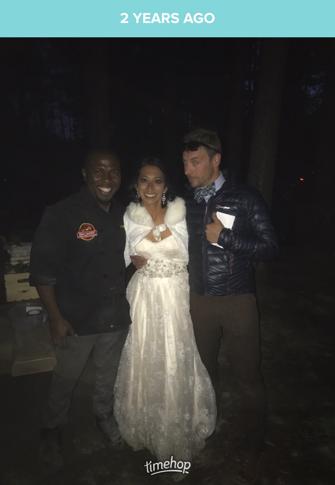 Chef Terry in BBQ Daddy chef coat with bride and groom at an outdoor forest wedding