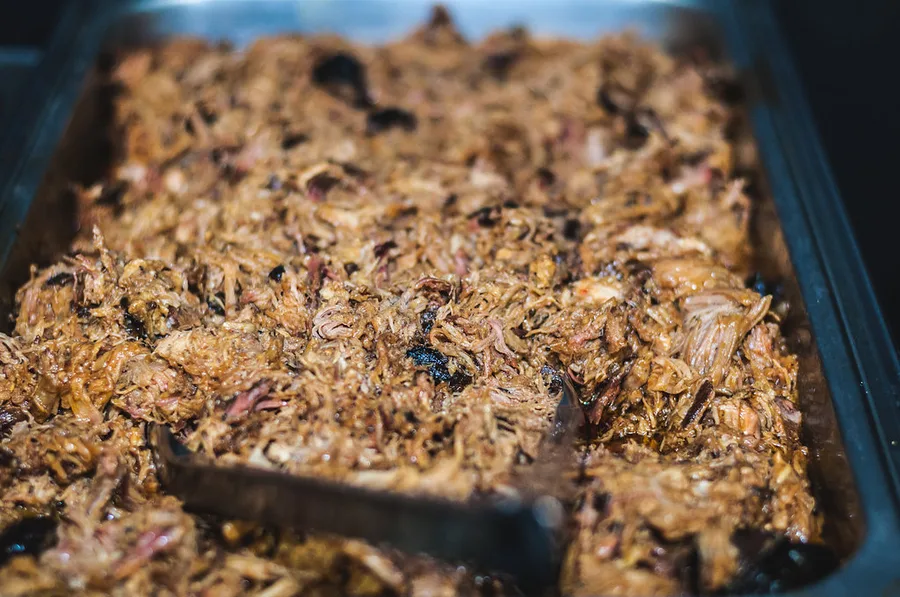 Hickory smoked pulled pork piled for BBQ catering