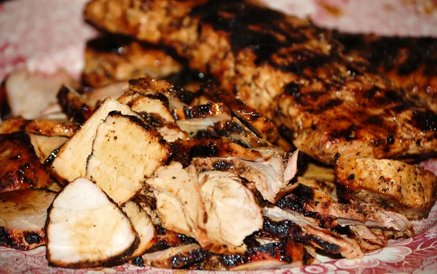 Grilled pork tenderloin sliced on a board